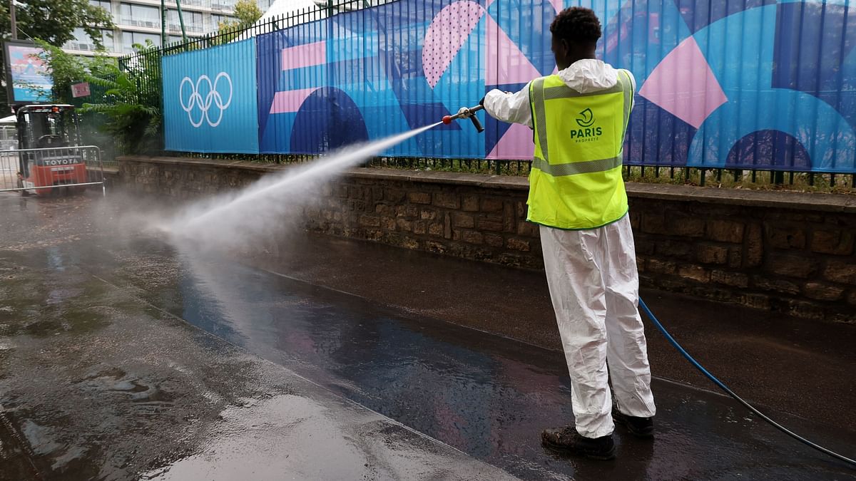 A worker is clicked cleaning the streets ahead of the Olympics in Paris.