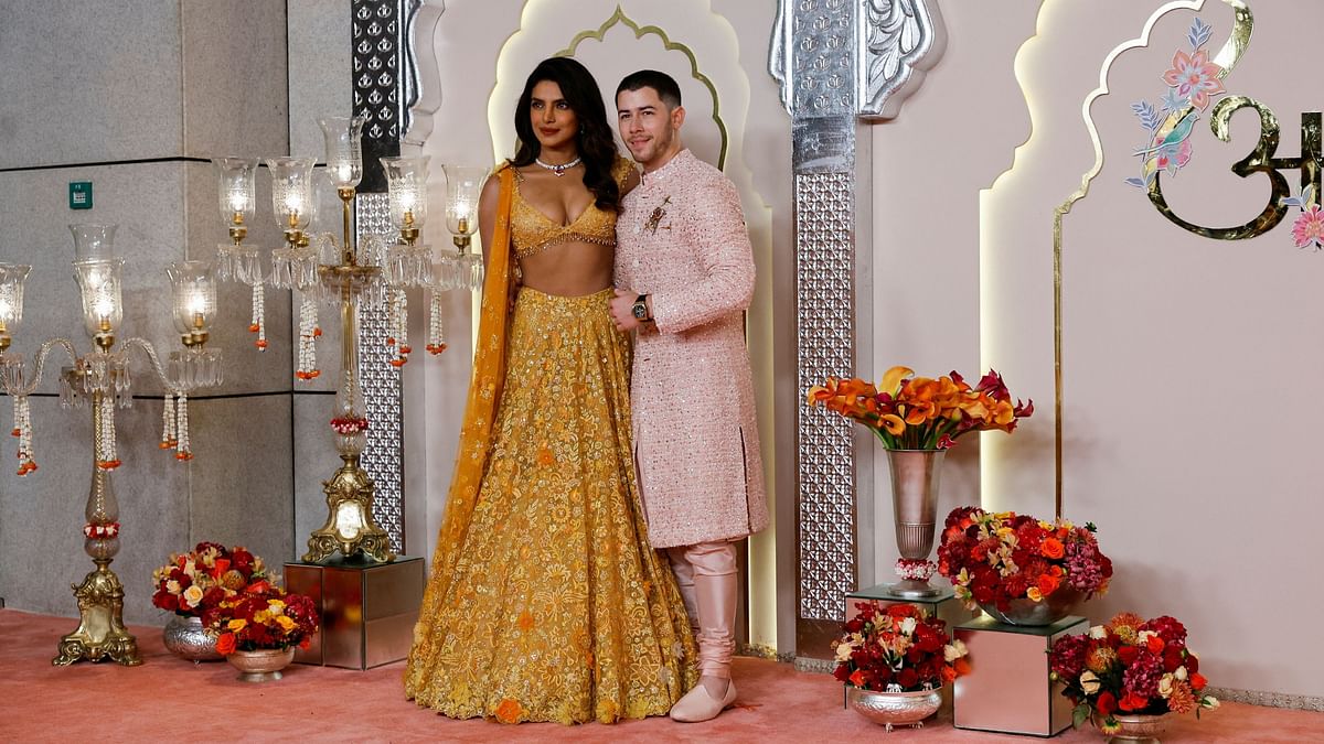 Priyanka and Nick pose for the cameras as they arrive for Anant Ambani and Radhika Merchant's wedding.