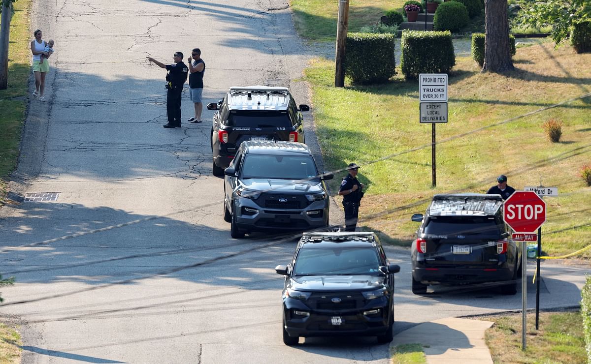 Law enforcement members guard the perimeter of the home of Trump shooting suspect, in Bethel Park.