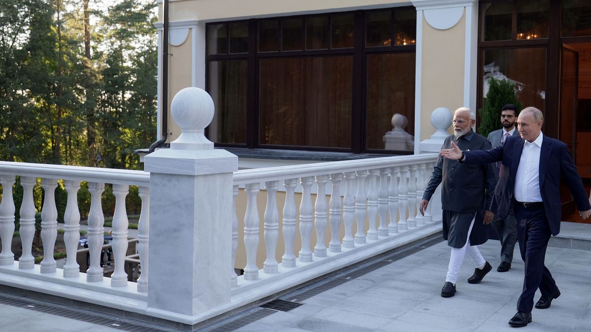 Vladimir Putin shows the way to Narendra Modi during their meeting at the Novo-Ogaryovo state residence near Moscow, Russia.