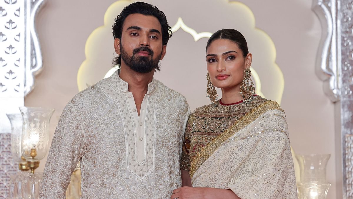 Cricketer KL Rahul and his wife Athiya Shetty pose for pictures on their arrival for Anant Ambani and Radhika Merchant's wedding.