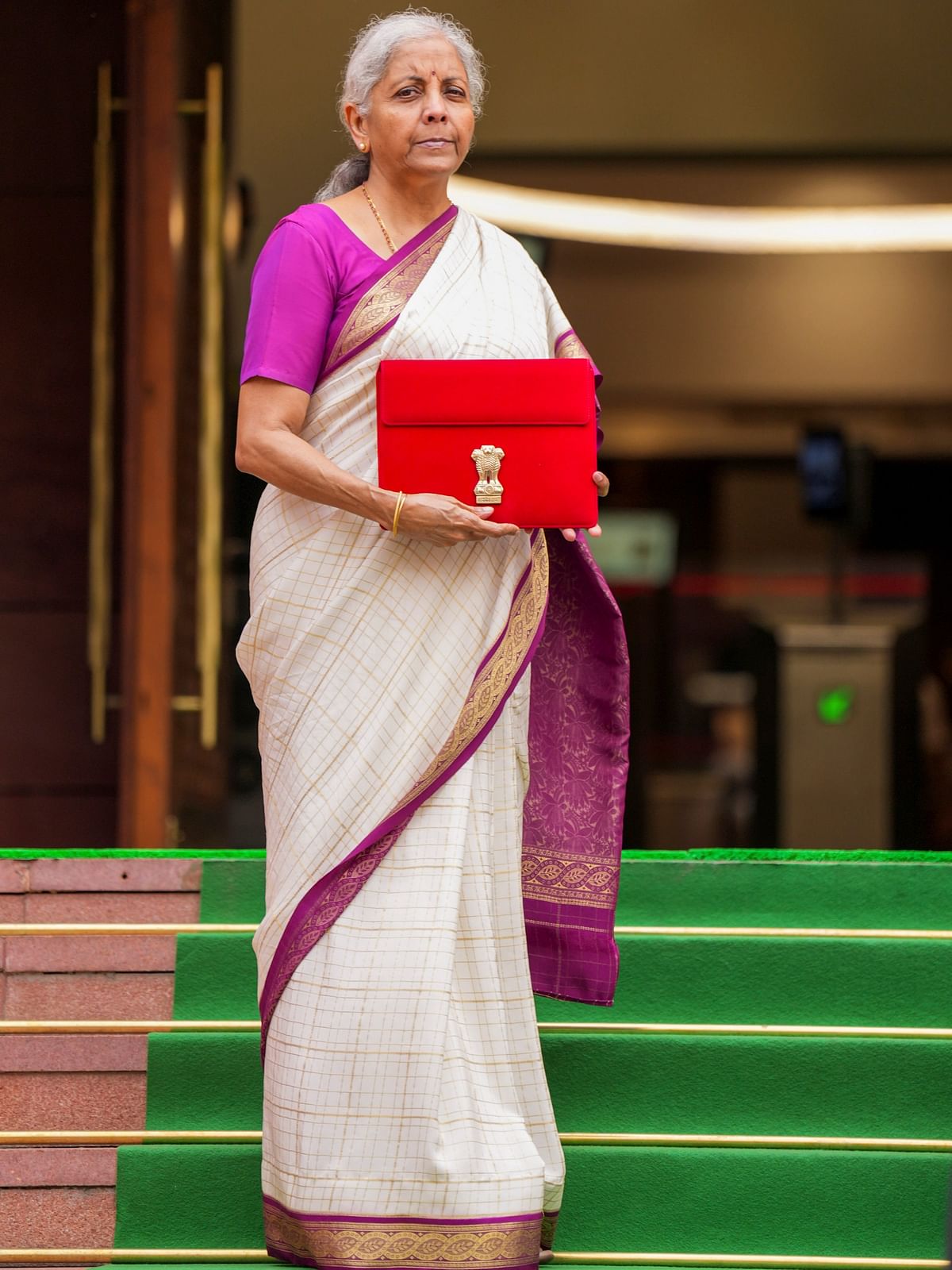 Union Budget 2024-25: Nirmala Sitharaman opted for an elegant beige saree with purple borders, complemented by a matching purple blouse.