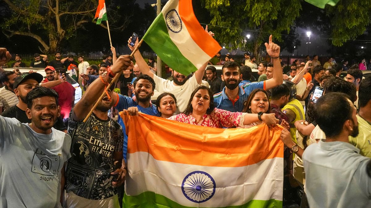 Fans celebrate on a road near the India Gate in New Delhi after India won the T20 World Cup. 