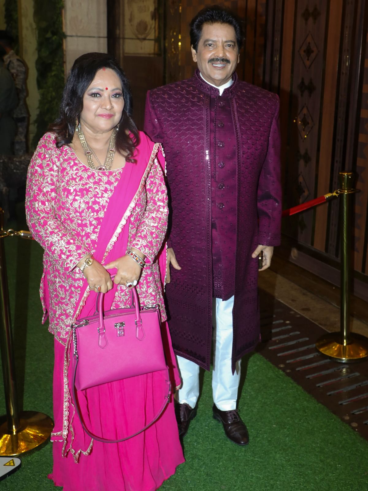 Singer Udit Narayan arrives with his wife Deepa Narayan Jha during the Haldi ceremony of Anant Ambani and Radhika Merchant, in Mumbai.