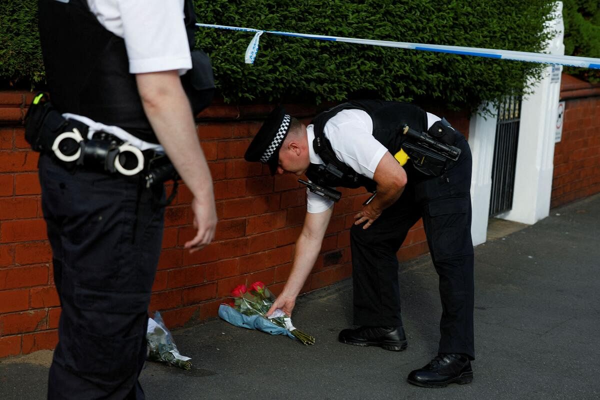 A police officer places flowers, given by residents, behind the police cordon near the scene of a stabbing incident in Southport, Britain, July 29, 2024. 