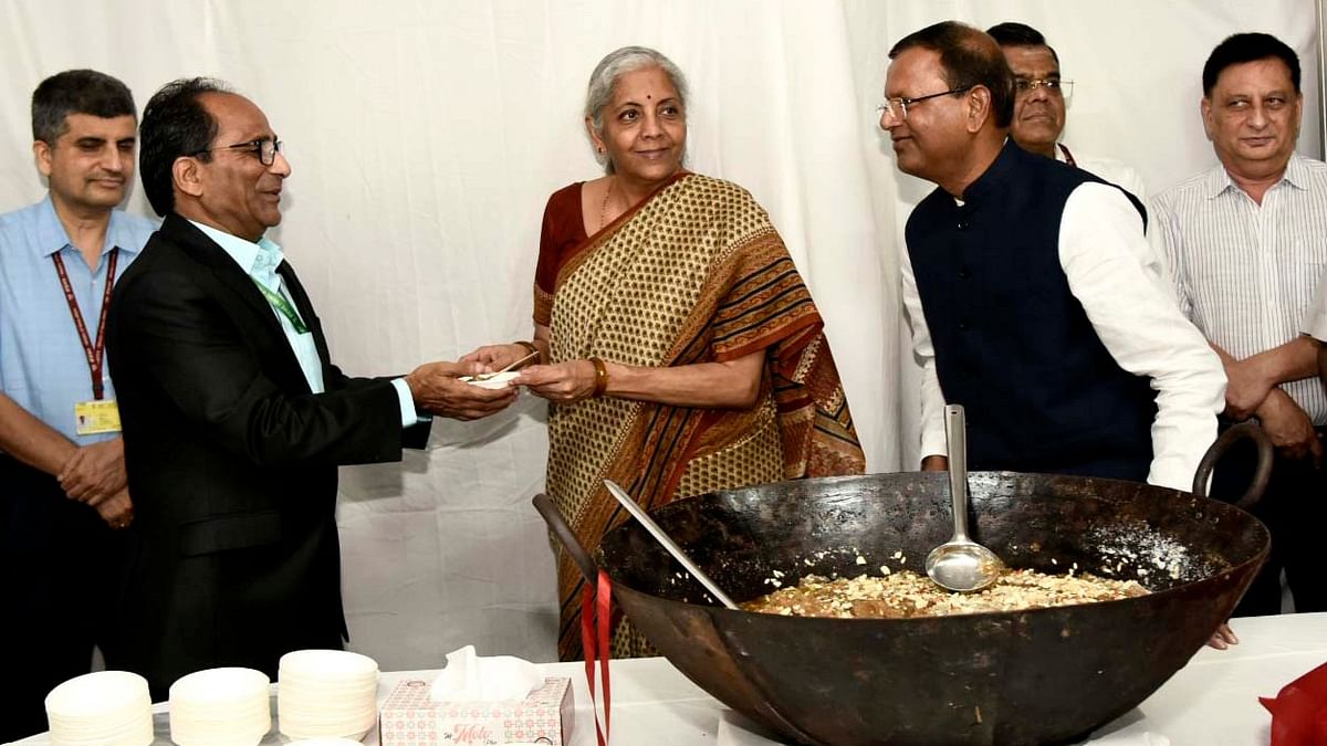 Union Minister for Finance and Corporate Affairs Nirmala Sitharaman distributes halwa to an official.