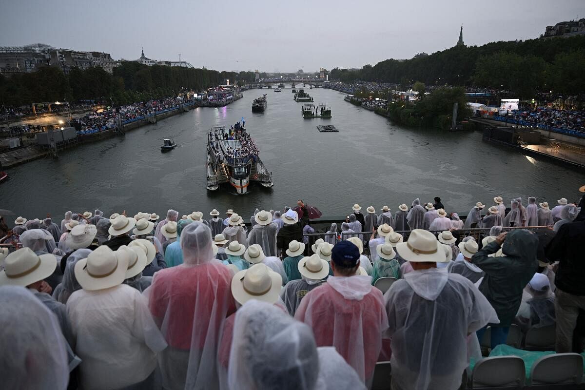 Boats carrying members of delegations sail along the Seine.