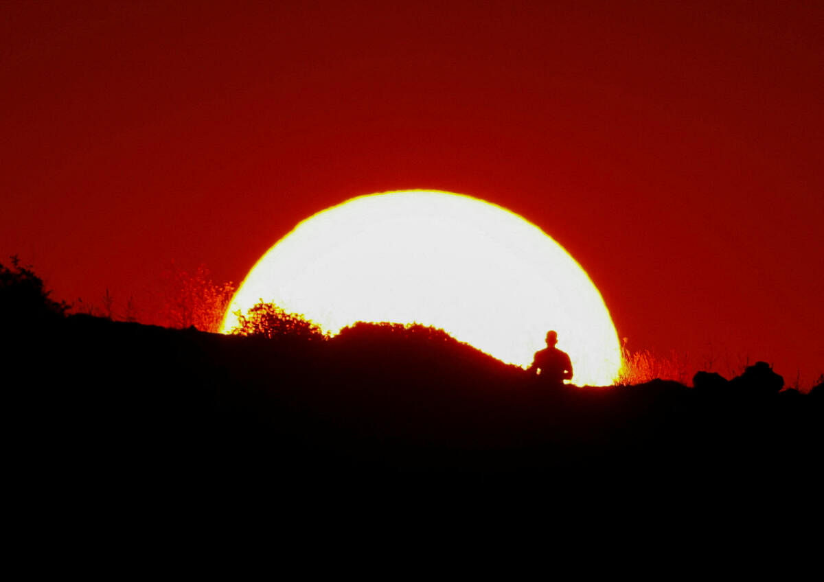 A man jogs at sunset in Pembroke, Malta, July 30, 2024. 