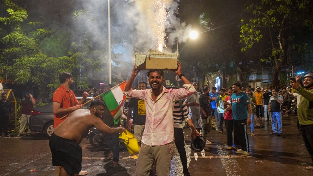 People celebrate India’s victory in the T20 World Cup final by bursting firecrackers, in Mumbai.