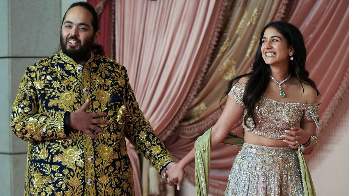 Anant Ambani arrives with his fiancee Radhika Merchant on the red carpet during their Sangeet ceremony.