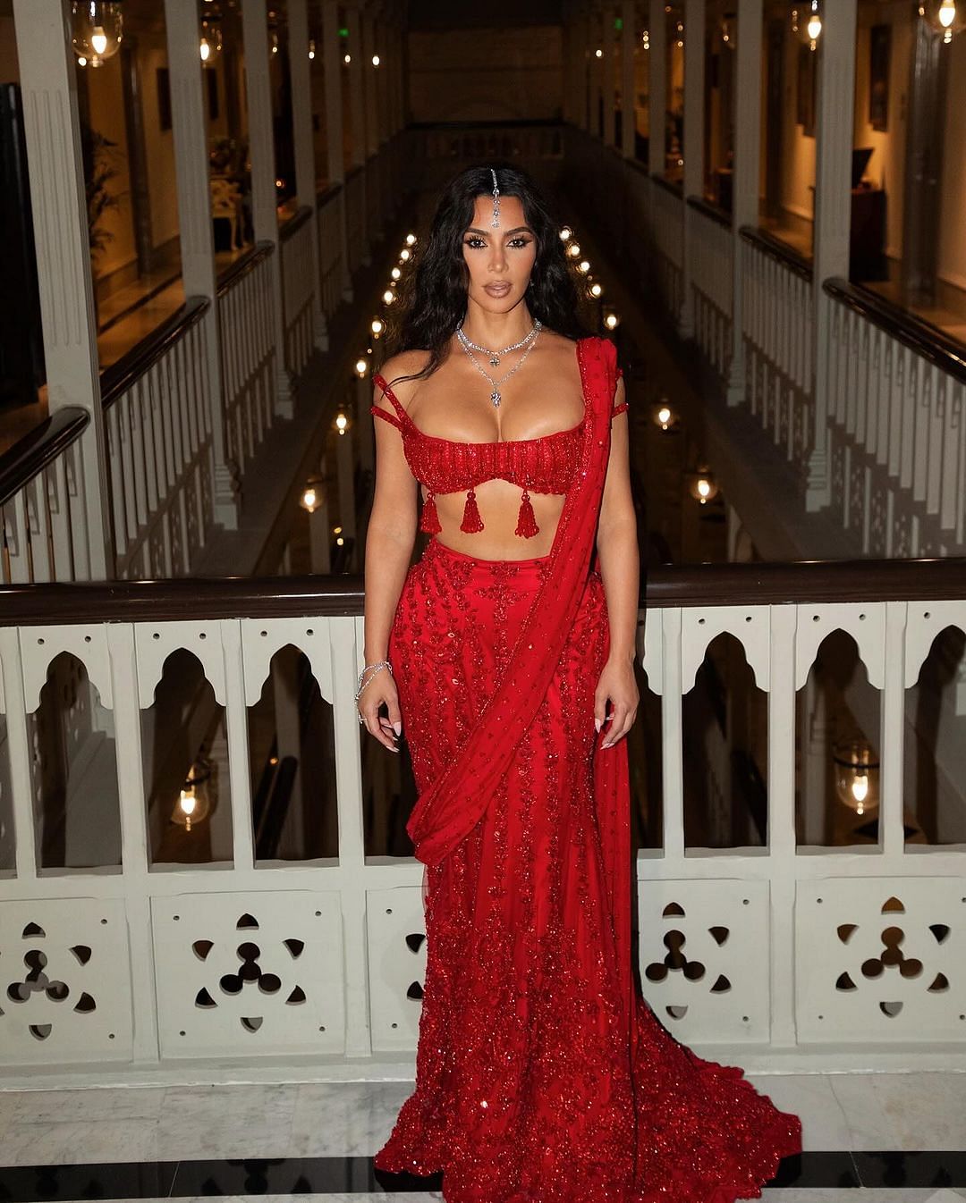 Kim Kardashian chose a custom-made Maharani red saree lehenga by Manish Malhotra for Anant-Radhika's wedding.