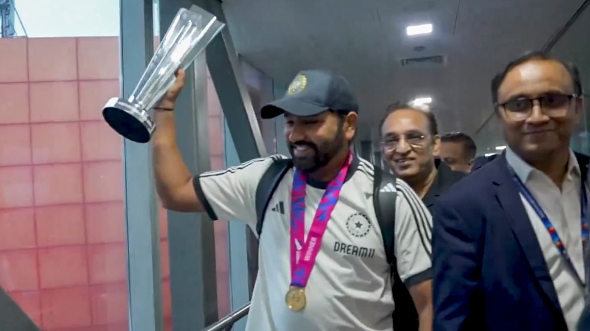 Indian cricket team captain Rohit Sharma shows the World Cup Trophy on his arrival at New Delhi airport.