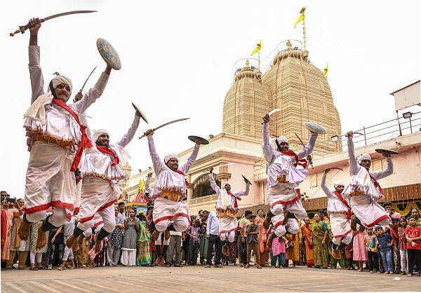 Devotees perform traditional dance on the eve of the annual Rath Yatra, at the Jagannath temple in Ahmedabad.