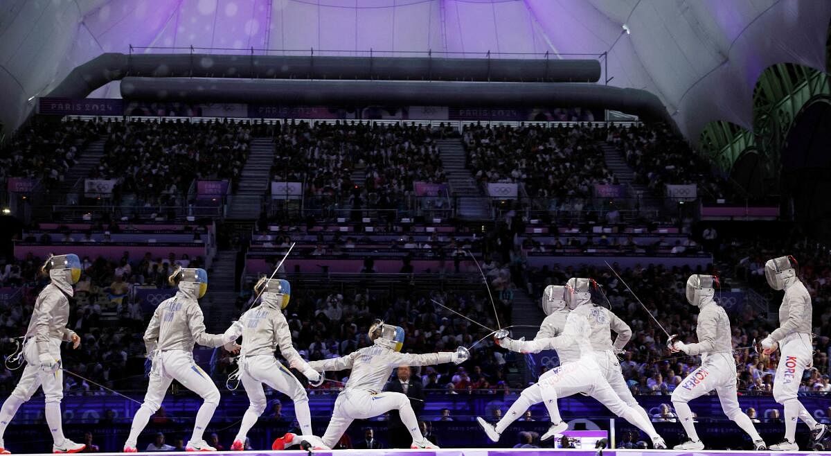 Paris 2024 Olympics - Fencing - Women's Sabre Team Gold Medal Match - Grand Palais, Paris, France - August 03, 2024. Sebin Choi of South Korea in action with Olga Kharlan of Ukraine during the Gold medal match. This is an in-camera multiple exposure picture.