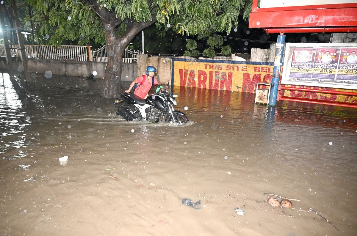 A motorcyclist struggles to navigate the Outer ring road near Veerannapalya. 