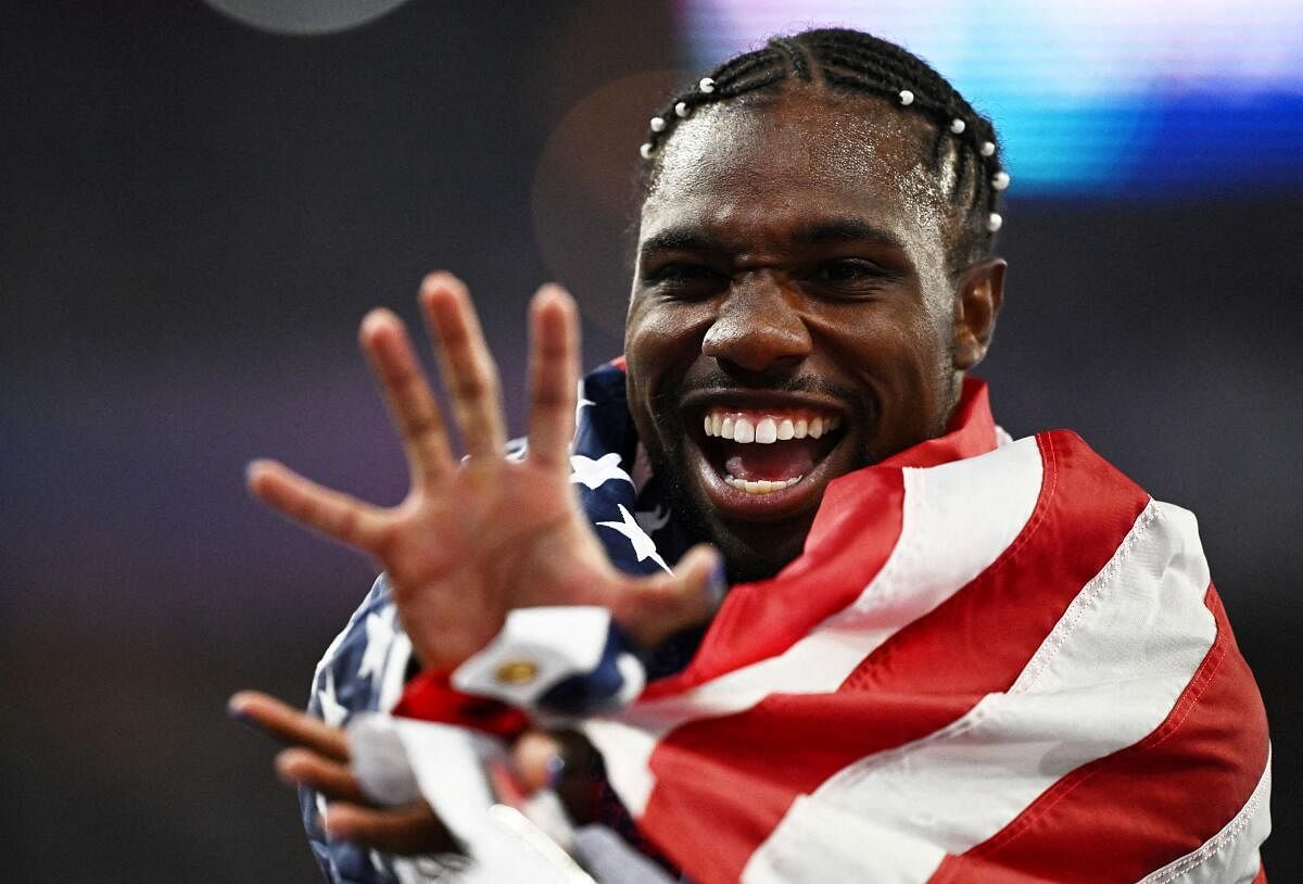 Paris 2024 Olympics - Athletics - Men's 100m Final - Stade de France, Saint-Denis, France - August 04, 2024. Noah Lyles of United States celebrates after winning gold.