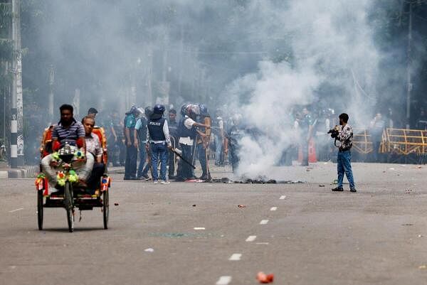 Smoke rises from a fire that was set on the street during a protest by students demanding the stepping down of Bangladeshi Prime Minister Sheikh Hasina, following quota reform protests, in Dhaka, Bangladesh. 