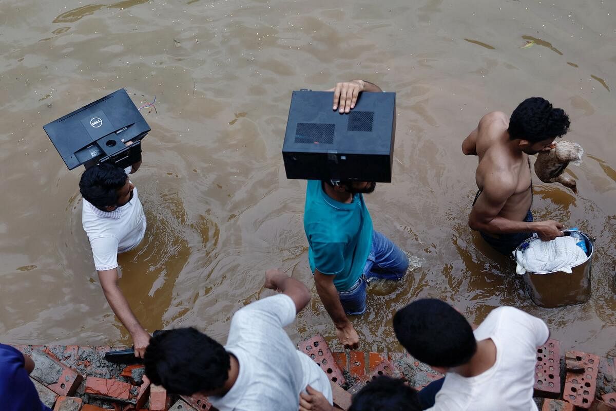 People loot a monitor, a computer and a duck from the Ganabhaban, the prime minister's residence, after the resignation of PM Sheikh Hasina in Dhaka, Bangladesh, August 5, 2024.