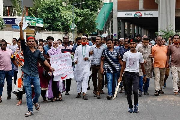 Protesters march on the street demanding the stepping down of Bangladeshi Prime Minister Sheikh Hasina, following quota reform protests by students, in Dhaka, Bangladesh, August 4, 2024.