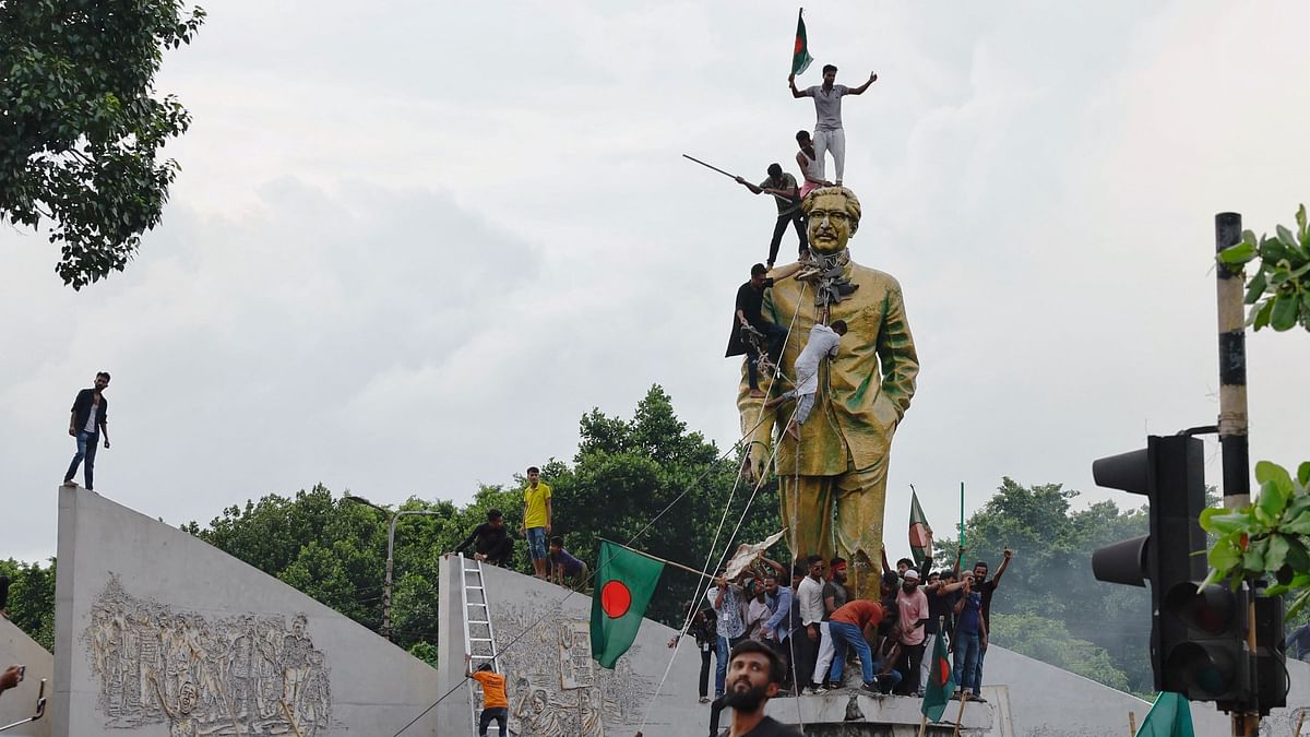 People vandalise the statue of Sheikh Mujibur Rahman at Bijoy Sarani area, the 'Father of the Nation', as they celebrate the resignation of the Prime Minister Sheikh Hasina in Dhaka, Bangladesh.