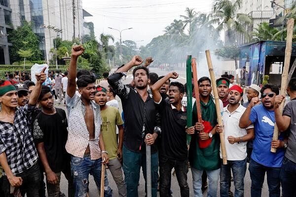 Demonstrators shout slogans after they have occupied a street during a protest demanding the stepping down of Bangladeshi Prime Minister Sheikh Hasina, following quota reform protests by students, in Dhaka, Bangladesh, August 4, 2024.