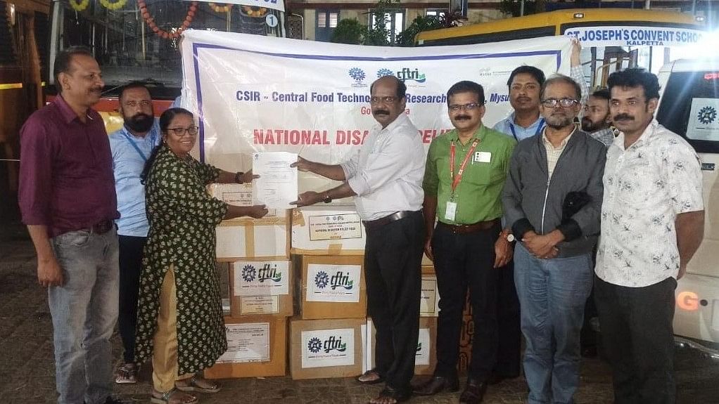 Staff of CSIR-CFTRI, Mysuru hand over food products to the representative of Government of Kerala. 