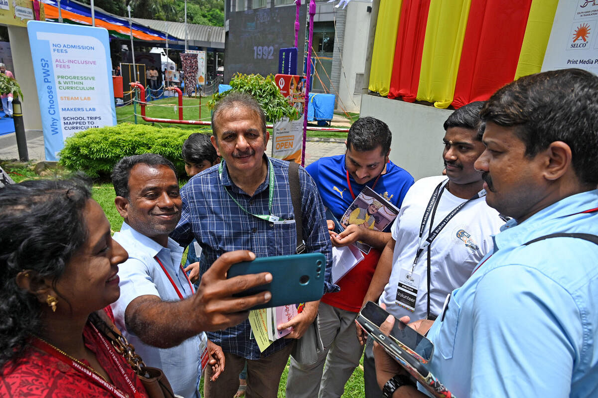 People take photos with poet, short story writer, playwright, Jayant Kaikini on first day of Book Brahma Literature Festival 2024.