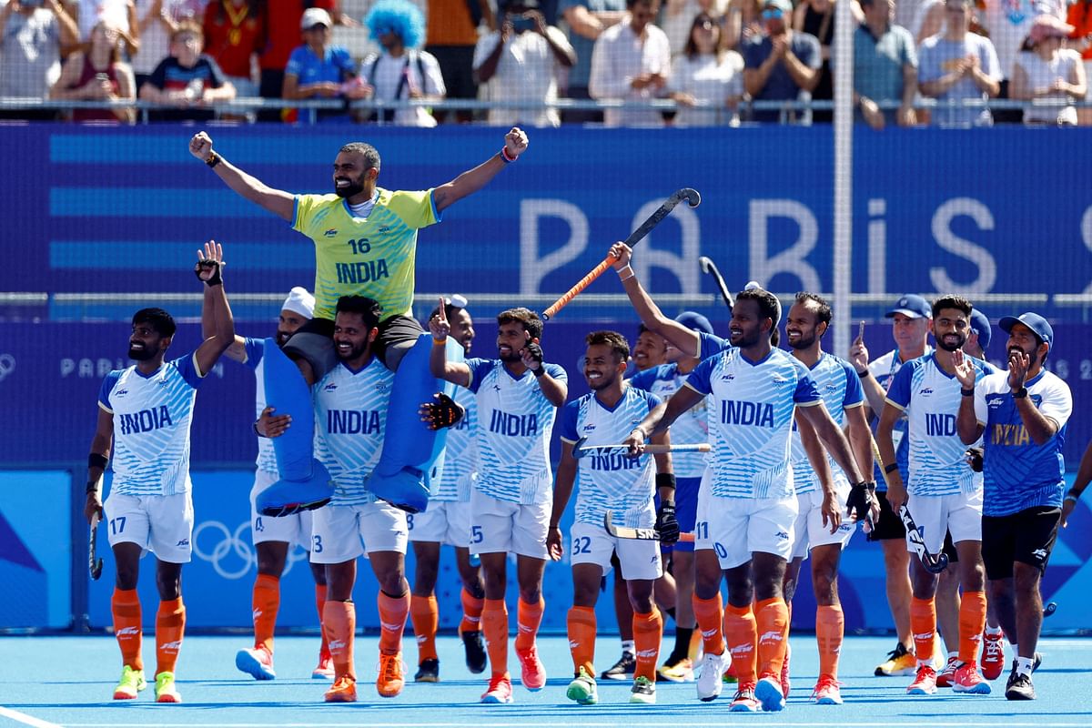 Sreejesh Parattu Raveendran of India, Harmanpreet Singh of India, Vivek Sagar Prasad of India and Sumit Sumit of India celebrate with teammates winning the match.