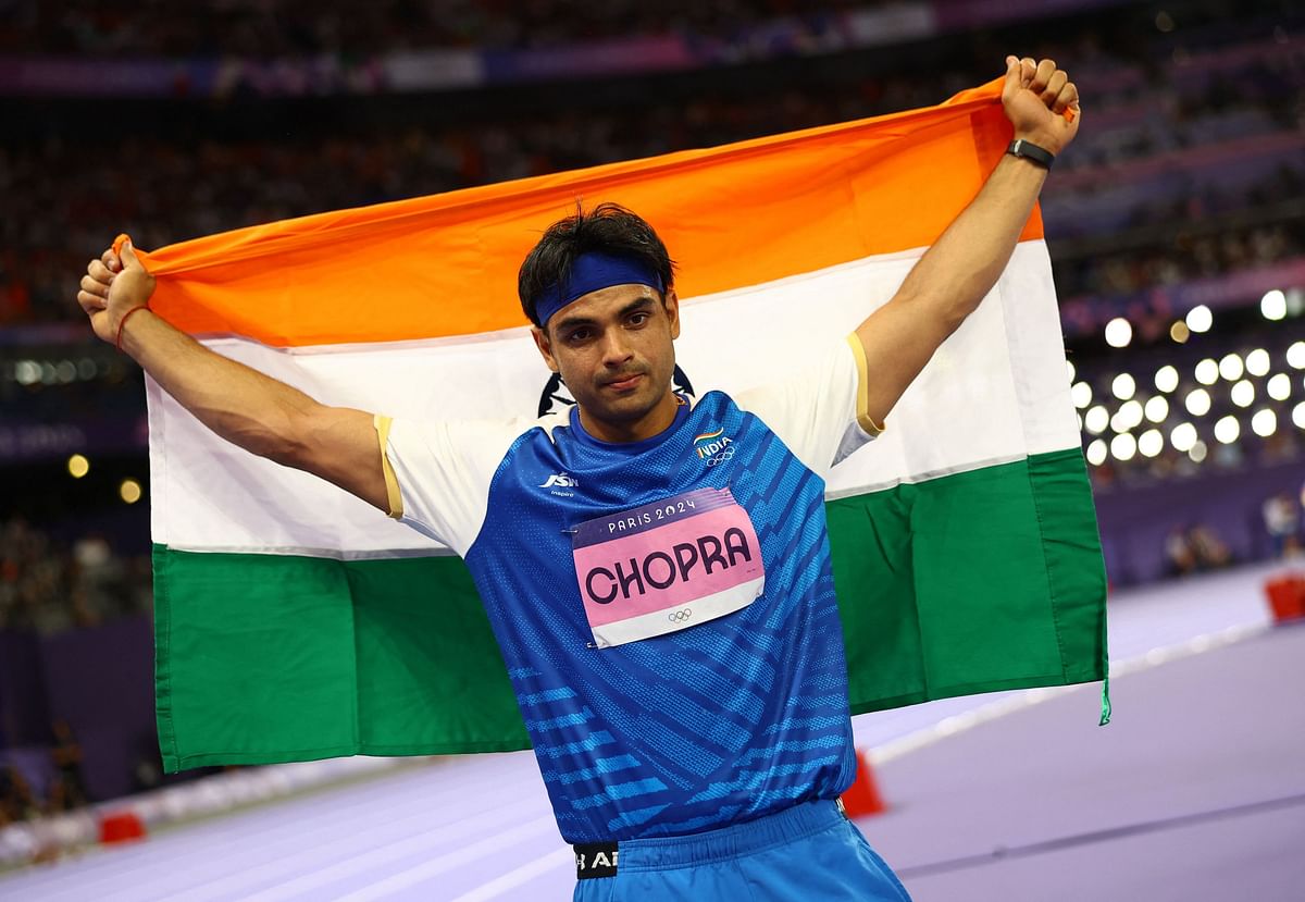 Neeraj Chopra of India celebrates with his national flag after winning silver