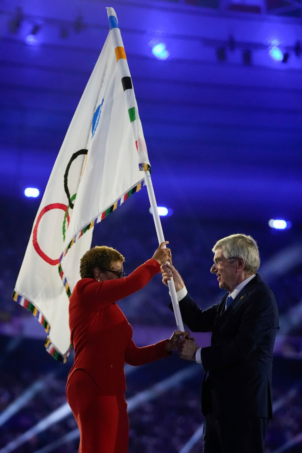 IOC President Thomas Bach (right) hands the Olympic flag to Los Angeles Mayor Karen Bass. LA will host the 2028 edition of the Olympics. 