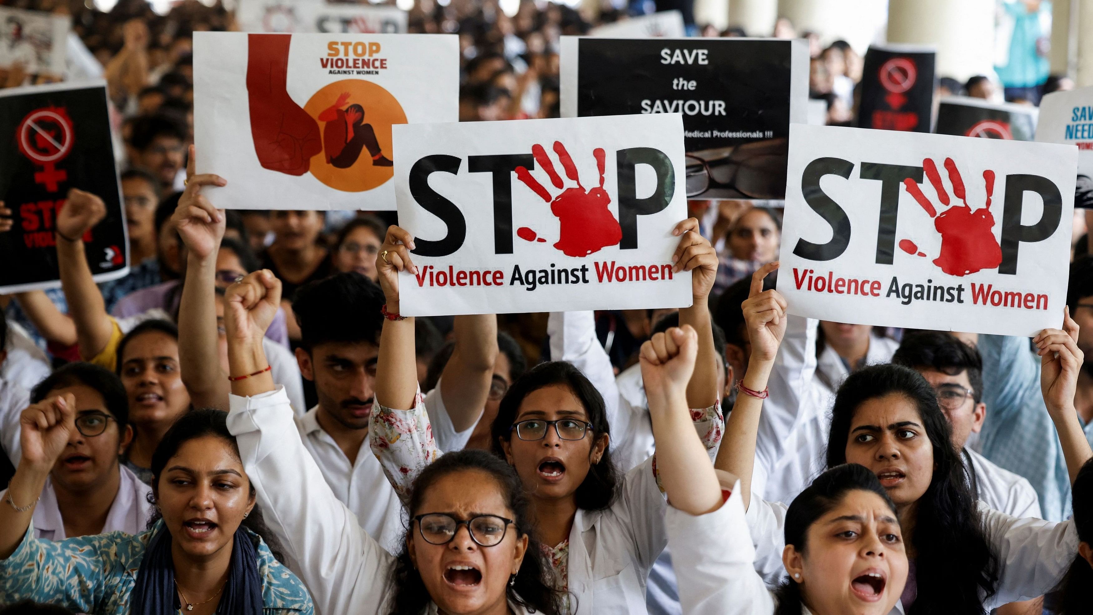 Doctors hold posters and shout slogans during the protest.