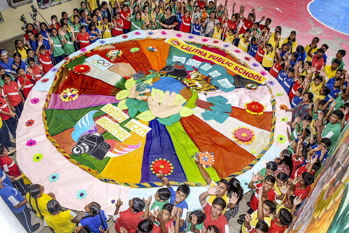 Students stand around a huge 'Rakhi during Raksha Bandhan celebrations, in Nagpur.