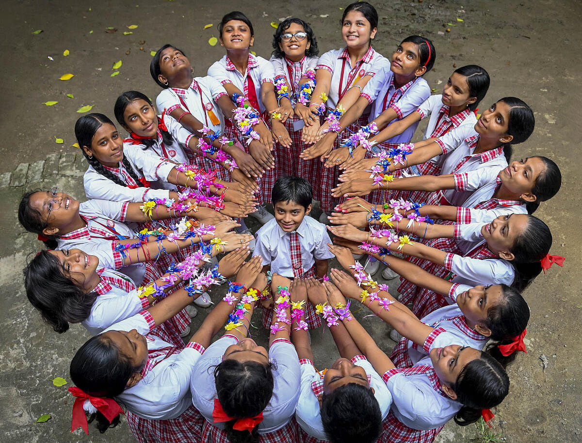 Students show their 'rakhis' ahead of the 'Raksha Bandhan' festival, in Nadia.