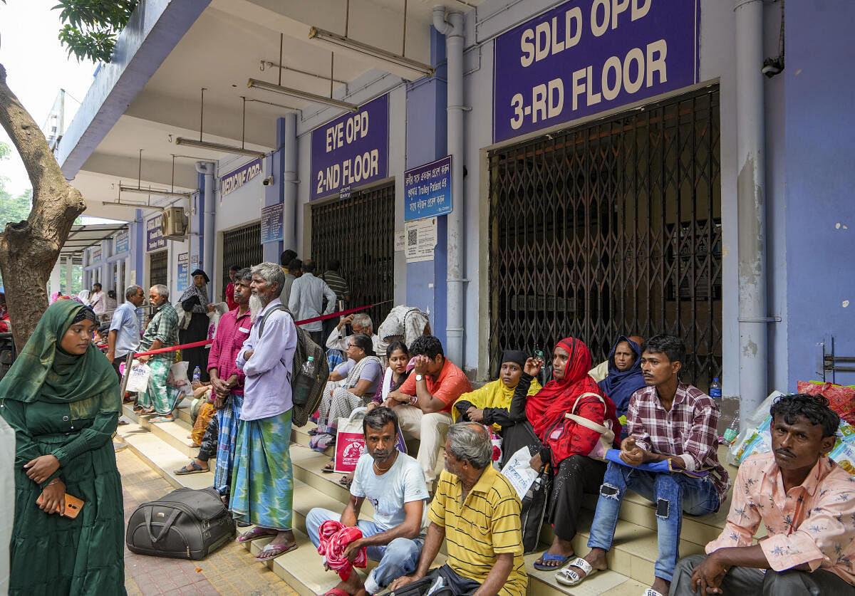 Patients wait outside the OPD of state government run SSKM hospital as doctors protest against the sexual assault and murder of a postgraduate trainee doctor, in Kolkata.