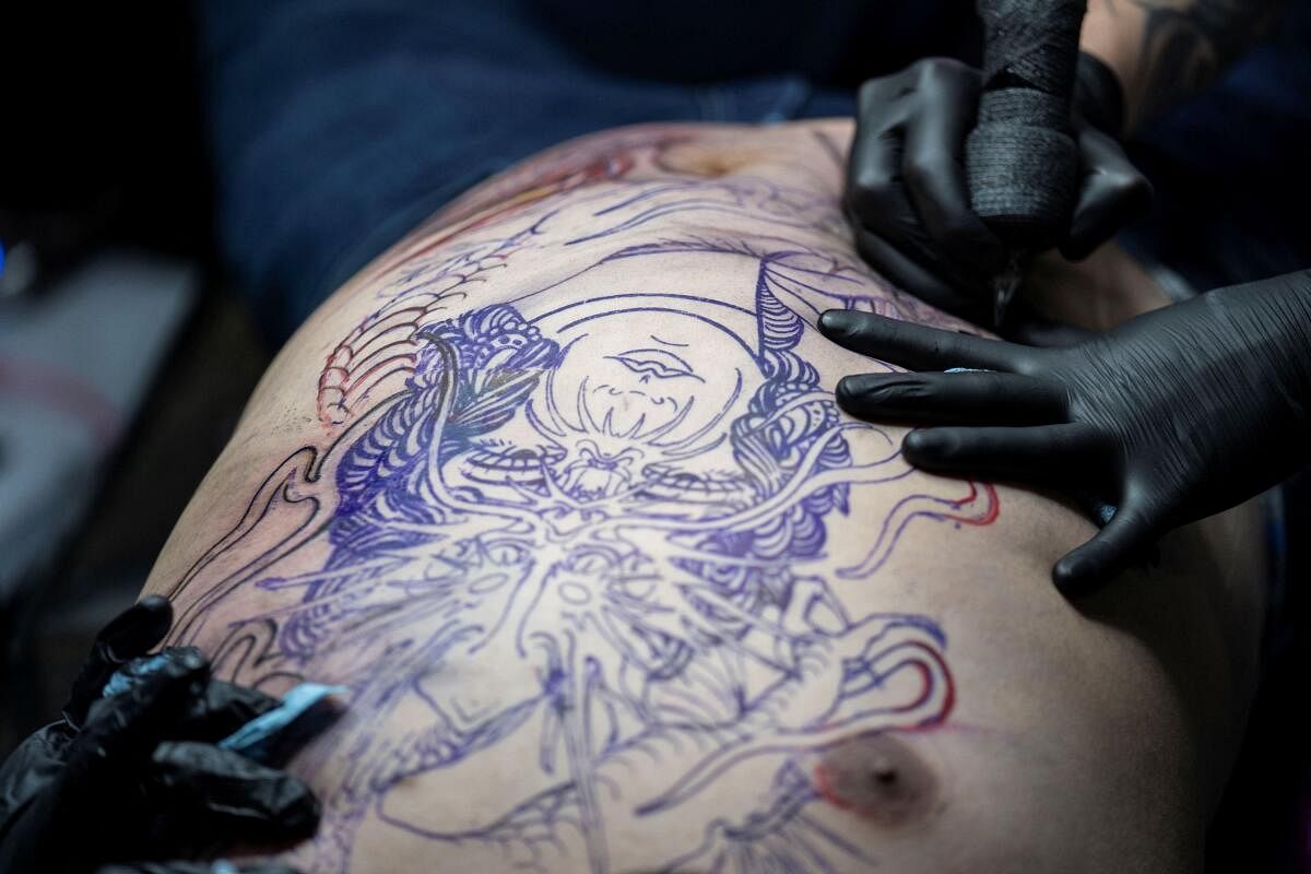 A person gets a tattoo done at the Mexico Tattoo Convention in Mexico City