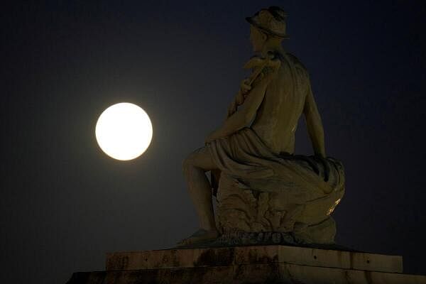 A supermoon, which occurs when a full moon coincides with the time of year when the Moon is closest to the Earth, rises over Copenhagen, Denmark.