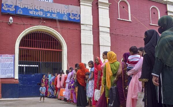 Women wait to celebrate Raksha Bandhan with their brothers lodged in the Bareilly Central Jail, in Bareilly, Monday.