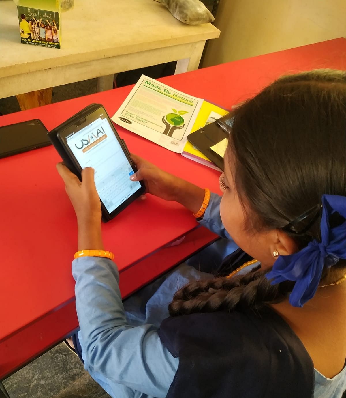 A student learns to use a tablet.