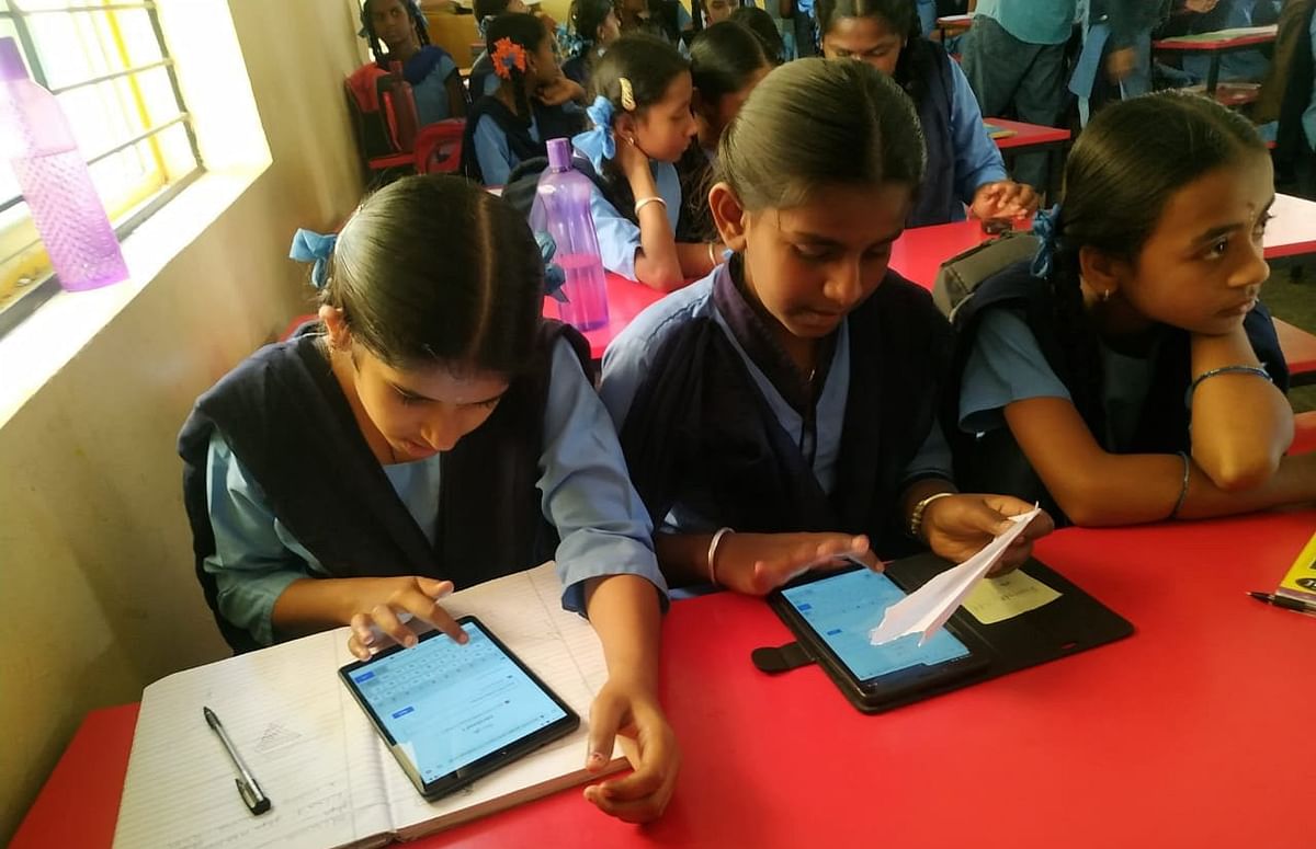 A student learns to use a tablet.