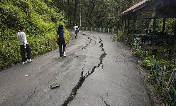 Cracks appear on a road following monsoon rainfall, in Shimla.