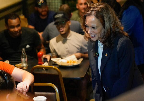 Democratic presidential nominee and U.S. Vice President Kamala Harris interacts with a customer as she visits Sandfly BBQ in Savannah, Georgia.