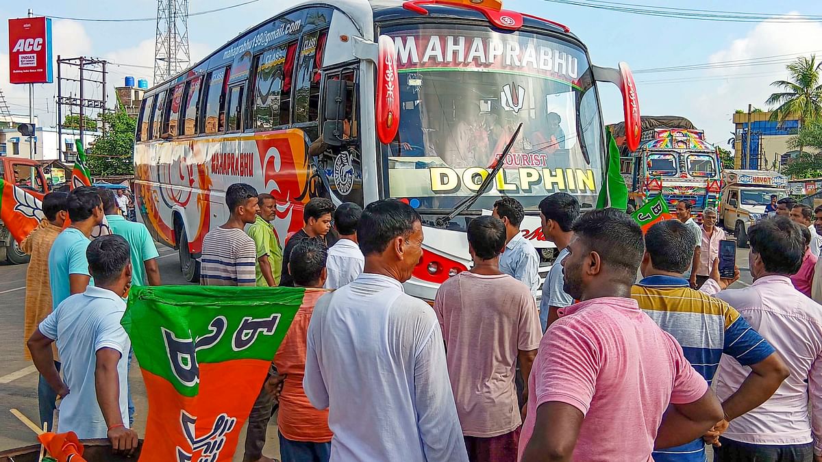 BJP workers stop a bus on National Highway 12 during the party's 12-hour general strike in Bengal.