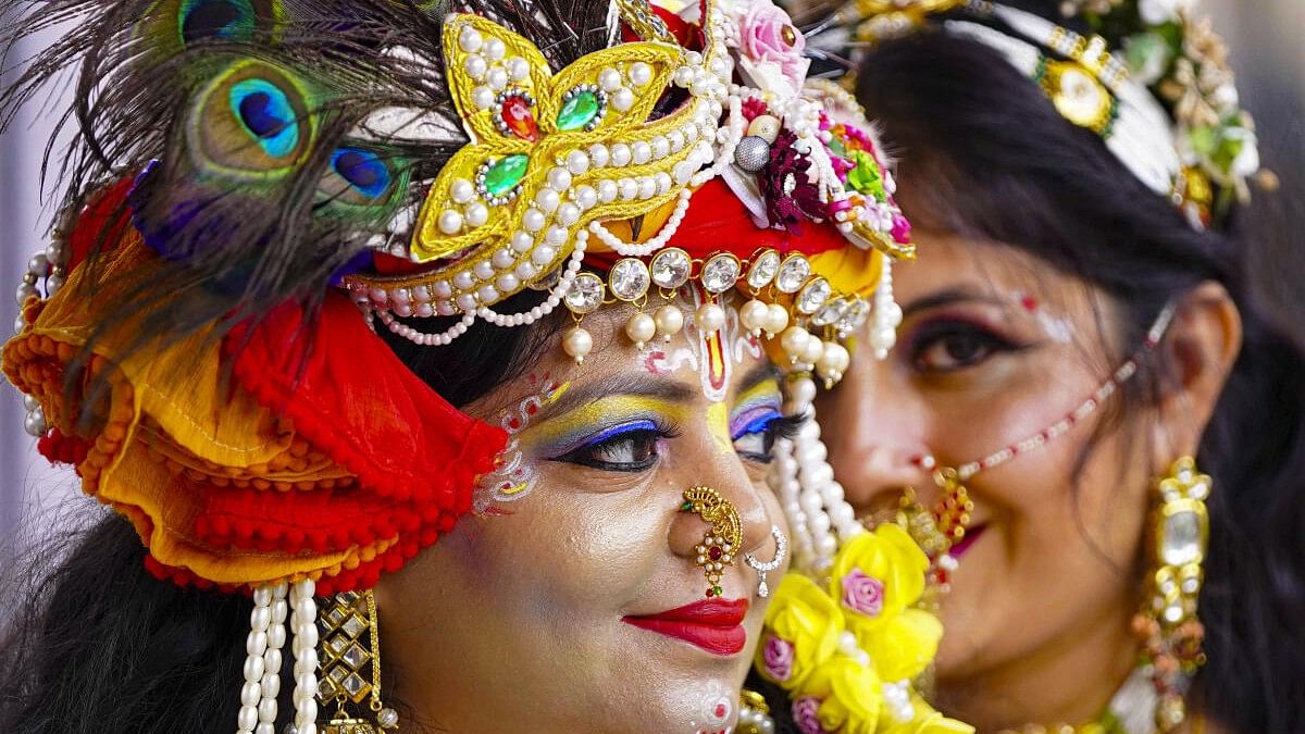 Devotees dressed as Radha and Krishna take part in 'Nand Utsav' during Krishna Janmashtami festival, in Ajmer.