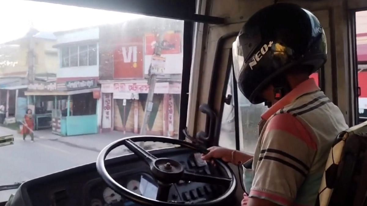 A man drives a government bus wearing helmet during BJP's 12-hour general strike in Bengal ('Bengal Bandh').