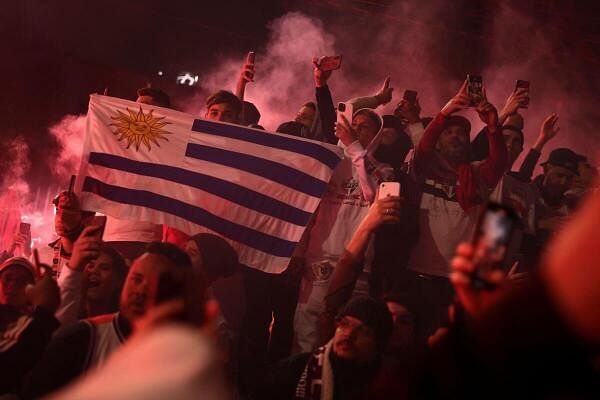 A Sao Paulo fan holds an Uruguayan flag as a tribute to Juan Izquierdo, Uruguay's Nacional footballer who died after collapsing during a Copa Libertadores match between Sao Paulo and Nacional, outside Morumbi stadium in Sao Paulo, Brazil.