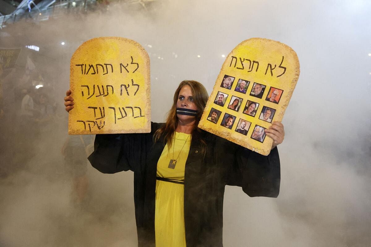 People gather to protest against the government and to show support for the hostages who were kidnapped during the deadly October 7 attack, in Tel Aviv