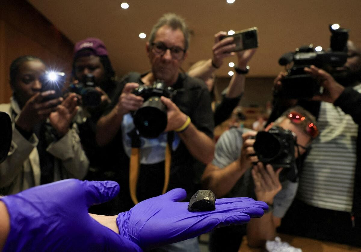 A researcher holds a fragment of meteorite during a press conference where researchers from the University of the Witwatersrand, Nelson Mandela University and Rhodes University explain the entry of a meteorite into Earth's atmosphere over South Africa last week, in Gqeberha, South Africa, September 3, 2024.