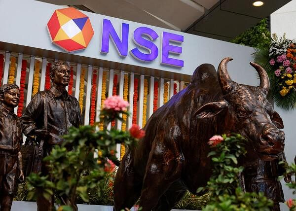 Statues of people and a bull are seen next to the logo of the National Stock Exchange (NSE) in Mumbai, India, September 6, 2024.