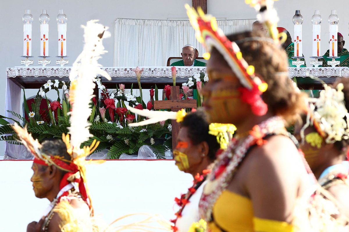 Indigenous people walk in front Pope Francis at the Sir John Guise Stadium in Port Moresby, Papua New Guinea, September 8, 2024.