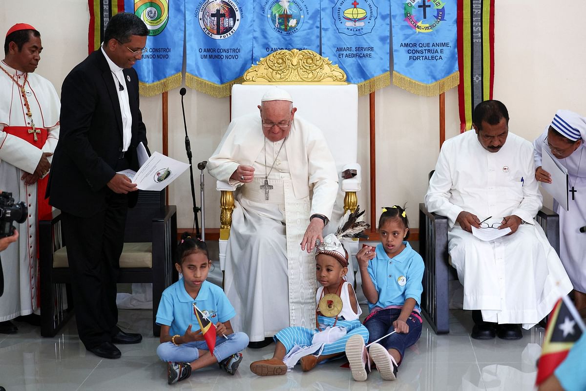 Pope Francis arrives for a visit to children with disabilities at the Irmas Alma School for Children, in Dili